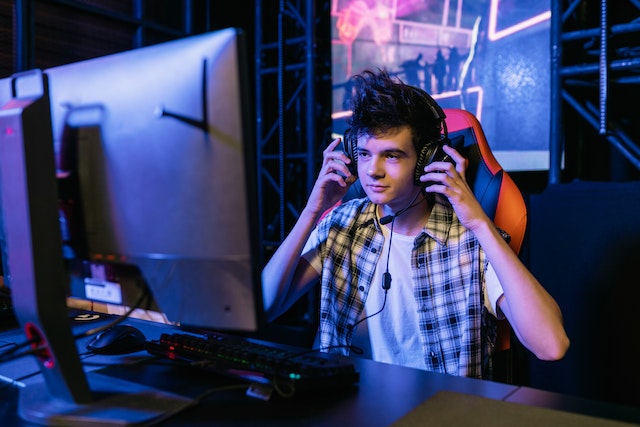 guy with headphones at the computer